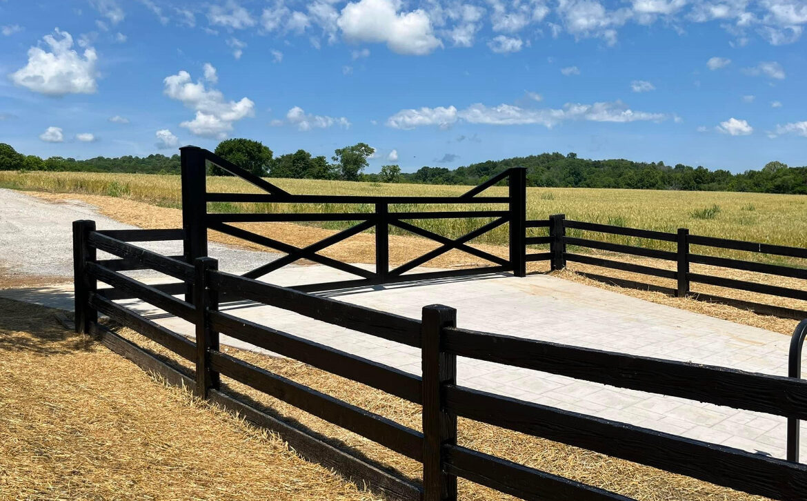 Concrete Fence Gate on Driveway in Cornfield
